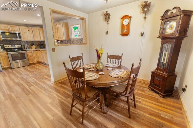 dining space featuring recessed lighting, baseboards, and light wood finished floors