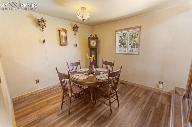 dining area with wood finished floors