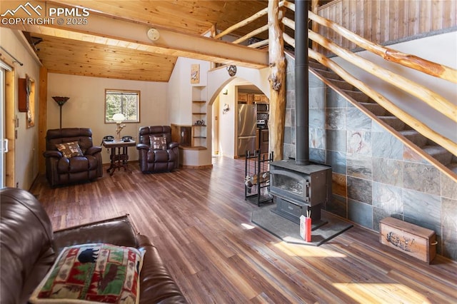 living area with arched walkways, vaulted ceiling with beams, wood ceiling, and wood finished floors