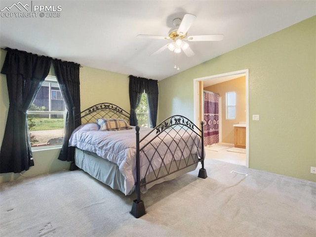 bedroom with carpet floors, a ceiling fan, and connected bathroom