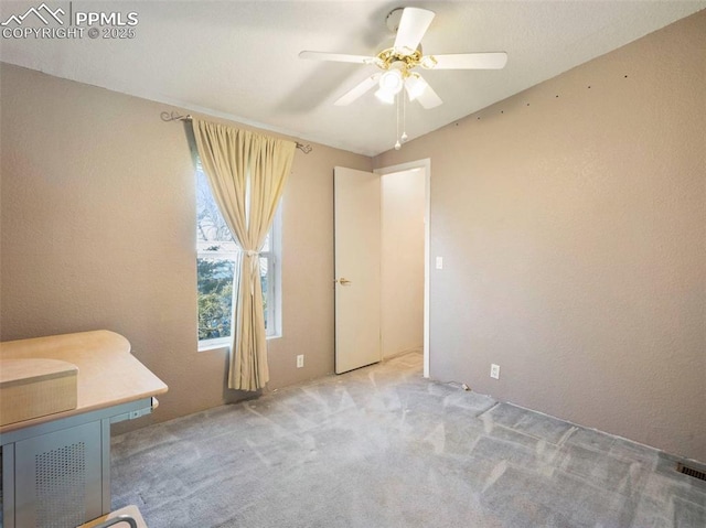 interior space featuring carpet flooring and ceiling fan