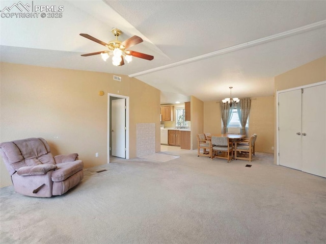 living room featuring light colored carpet, vaulted ceiling, visible vents, and ceiling fan with notable chandelier