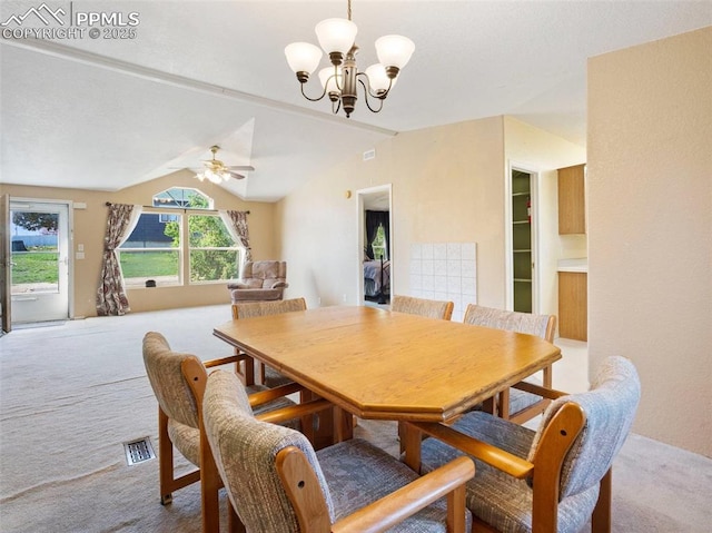 carpeted dining room featuring visible vents, vaulted ceiling, and ceiling fan with notable chandelier