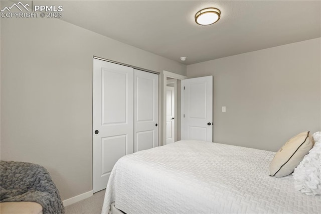 bedroom featuring baseboards, light colored carpet, and a closet