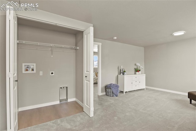 laundry room featuring laundry area, hookup for a washing machine, carpet floors, baseboards, and electric dryer hookup