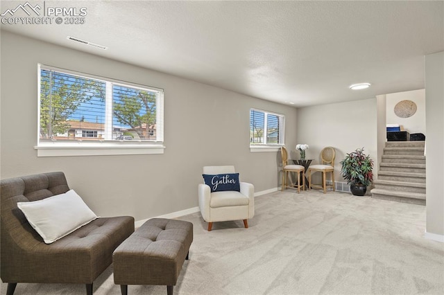 living area featuring stairway, baseboards, carpet, and visible vents
