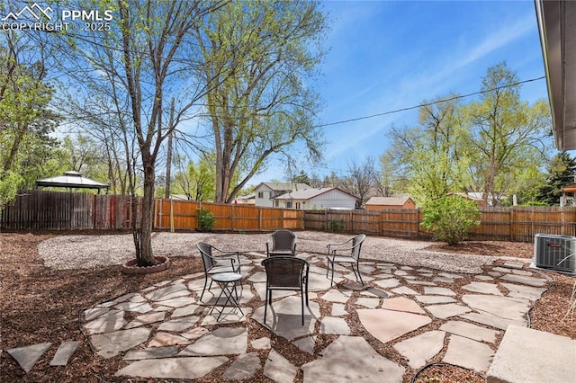 view of patio / terrace featuring a gazebo, central AC unit, and a fenced backyard