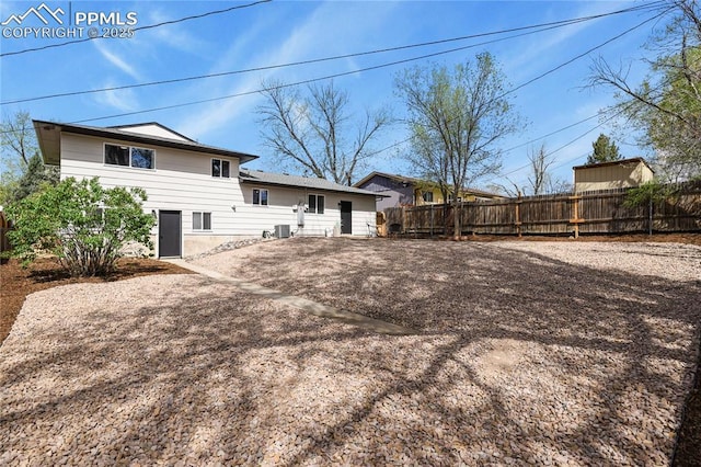 back of house with fence and cooling unit