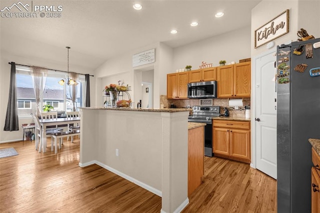 kitchen with appliances with stainless steel finishes, light wood finished floors, backsplash, recessed lighting, and hanging light fixtures