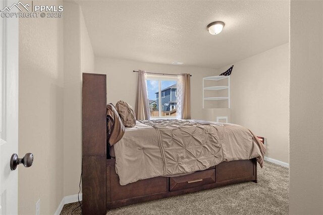 carpeted bedroom with baseboards and a textured ceiling