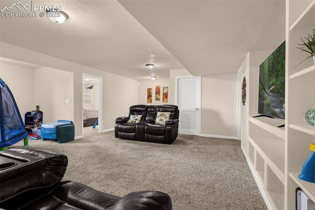 living area featuring carpet flooring, a textured ceiling, and baseboards