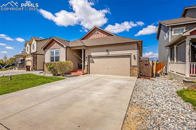 view of front of home featuring board and batten siding, stone siding, an attached garage, and concrete driveway