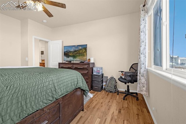 bedroom featuring light wood-type flooring, baseboards, and ceiling fan