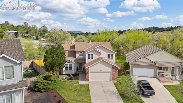 7665 Calloway Ct, Colorado Springs, CO 80919 - view of front facade with concrete driveway and brick siding