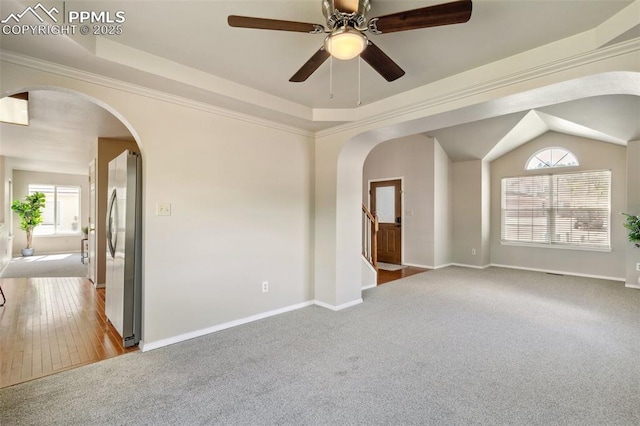 7665 Calloway Ct, Colorado Springs, CO 80919 - empty room featuring arched walkways, carpet, and healthy amount of natural light