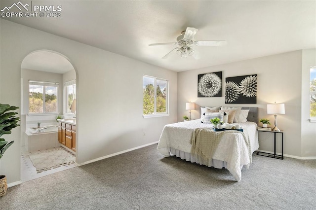7665 Calloway Ct, Colorado Springs, CO 80919 - carpeted bedroom with multiple windows, baseboards, arched walkways, and a ceiling fan