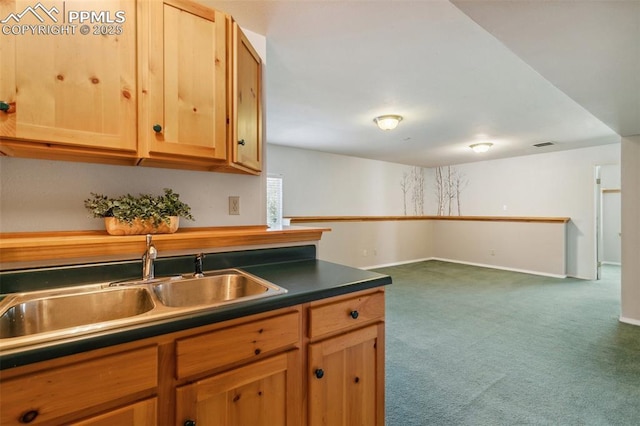 7665 Calloway Ct, Colorado Springs, CO 80919 - kitchen with a sink, dark carpet, dark countertops, baseboards, and light brown cabinetry