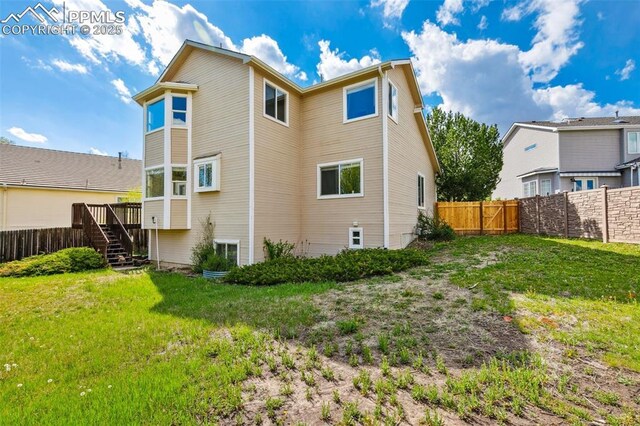 7665 Calloway Ct, Colorado Springs, CO 80919 - rear view of house featuring stairway and a wooden deck