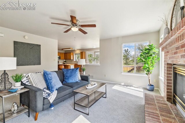 7665 Calloway Ct, Colorado Springs, CO 80919 - living area featuring a brick fireplace, carpet, baseboards, and a ceiling fan