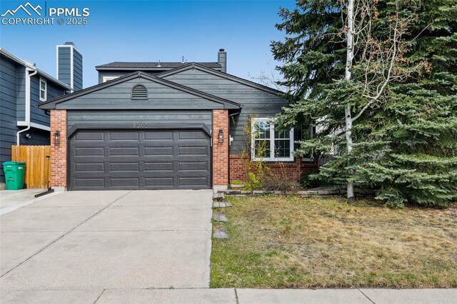 8365 Pepperridge Dr, Colorado Springs, CO 80920 - single story home with driveway, a garage, brick siding, a chimney, and fence