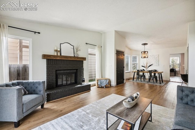 8365 Pepperridge Dr, Colorado Springs, CO 80920 - living room featuring wood finished floors and a brick fireplace