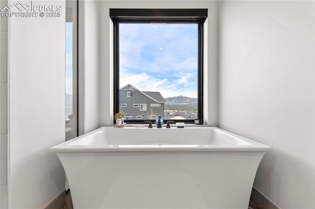 full bath featuring a soaking tub