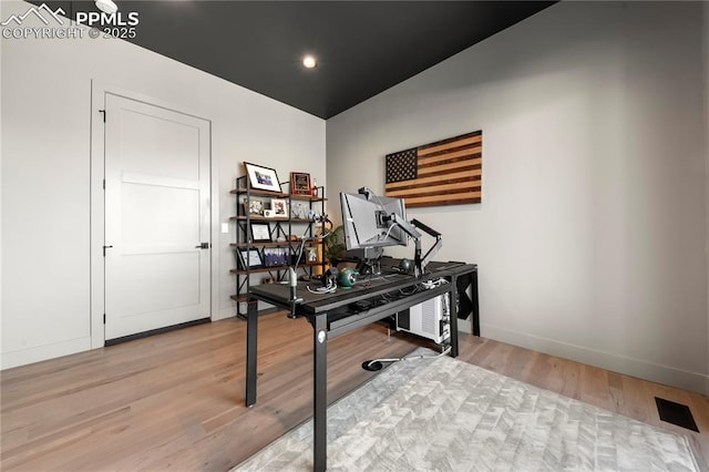 office space featuring baseboards and light wood-type flooring