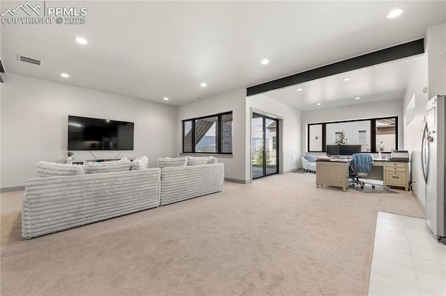 living area featuring visible vents, recessed lighting, baseboards, and light carpet