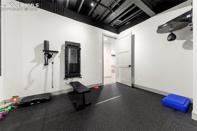 workout room featuring baseboards