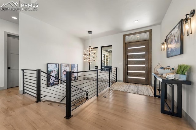 entrance foyer with recessed lighting, baseboards, and wood finished floors