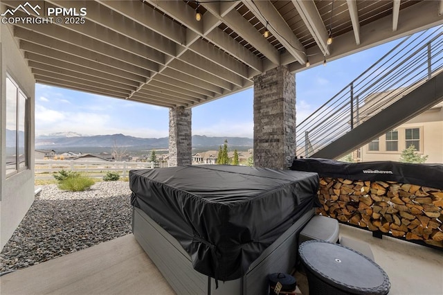 view of patio / terrace with a grill, a mountain view, and fence