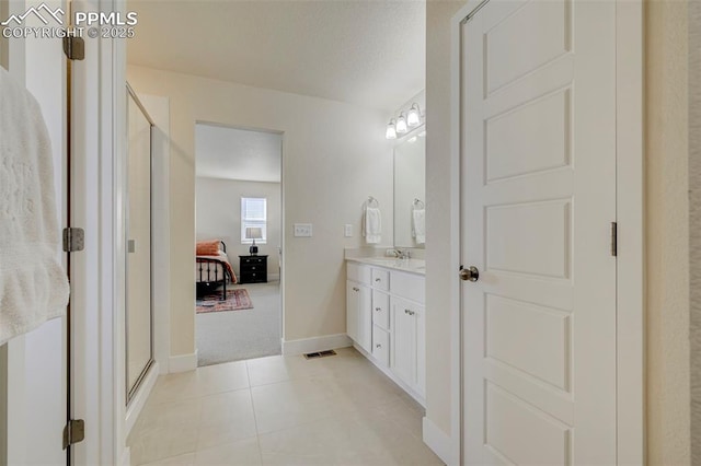 9773 Marble Canyon Way, Peyton, CO 80831 - ensuite bathroom with vanity, a shower stall, tile patterned flooring, and baseboards