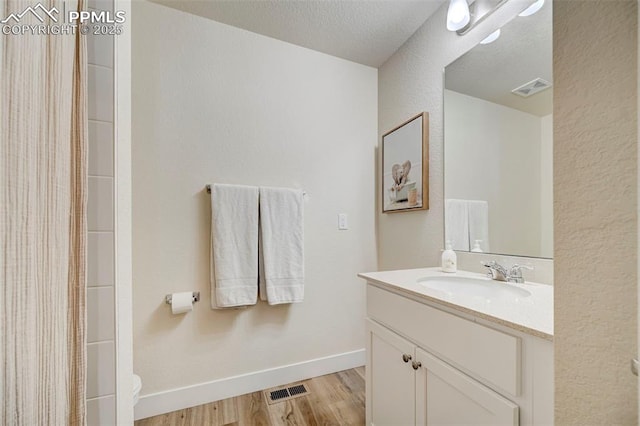 9773 Marble Canyon Way, Peyton, CO 80831 - bathroom featuring vanity, toilet, wood finished floors, and a shower with curtain