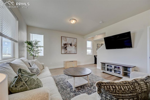9773 Marble Canyon Way, Peyton, CO 80831 - living area featuring wood finished floors, baseboards, and stairway