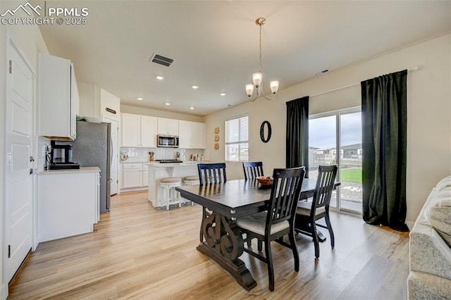 9773 Marble Canyon Way, Peyton, CO 80831 - dining room with light wood finished floors, a chandelier, and recessed lighting