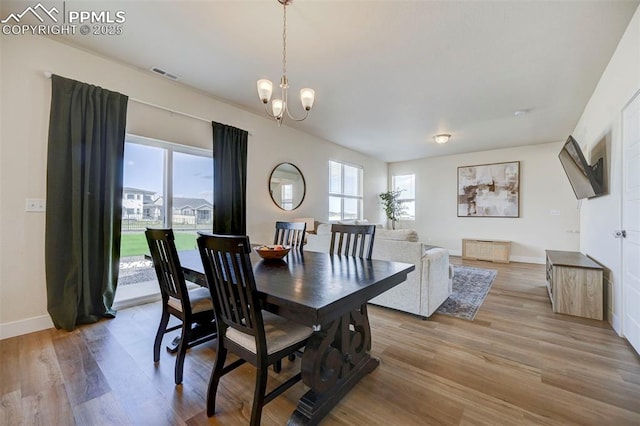 9773 Marble Canyon Way, Peyton, CO 80831 - dining area with baseboards, light wood-style floors, and a chandelier