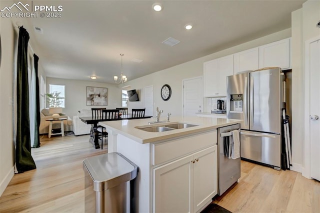 9773 Marble Canyon Way, Peyton, CO 80831 - kitchen with stainless steel appliances, a sink, light wood-style floors, white cabinetry, and recessed lighting