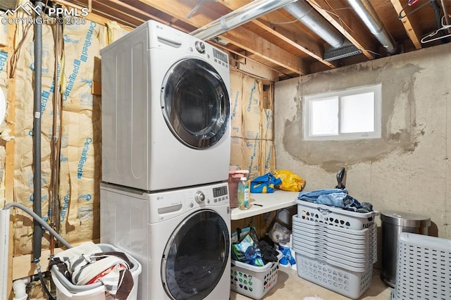 clothes washing area with laundry area and stacked washer and clothes dryer