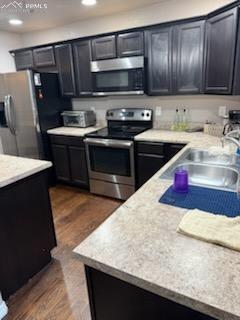 6290 Pilgrimage Rd, Colorado Springs, CO 80925 - kitchen featuring a sink, dark wood-style floors, light countertops, appliances with stainless steel finishes, and recessed lighting