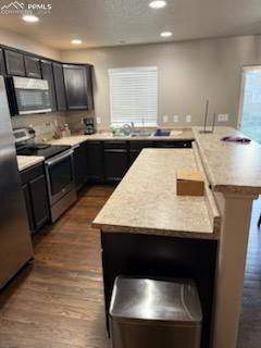6290 Pilgrimage Rd, Colorado Springs, CO 80925 - kitchen featuring recessed lighting, light countertops, dark wood-style floors, and appliances with stainless steel finishes