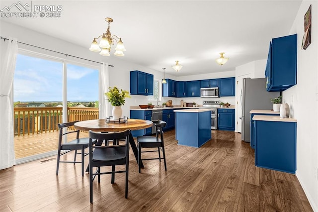 dining room with a healthy amount of sunlight, wood finished floors, and a notable chandelier