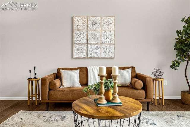 living area featuring baseboards and wood finished floors