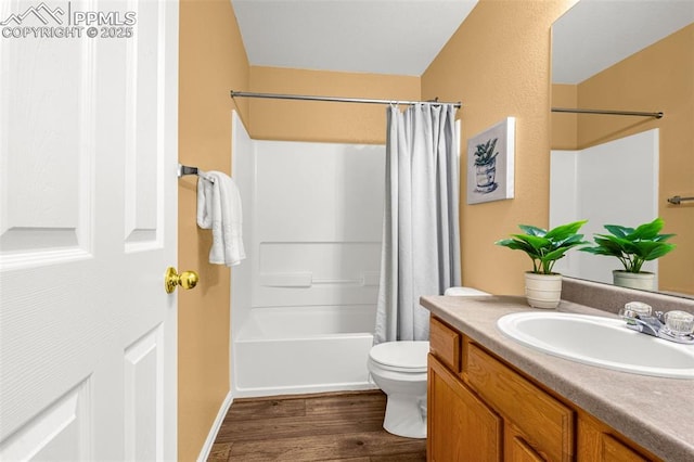 full bathroom featuring vanity, wood finished floors, shower / bath combo, and toilet