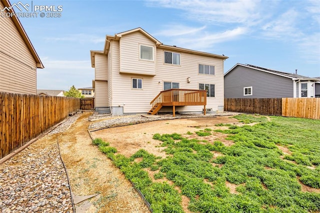 back of house featuring a fenced backyard and a deck