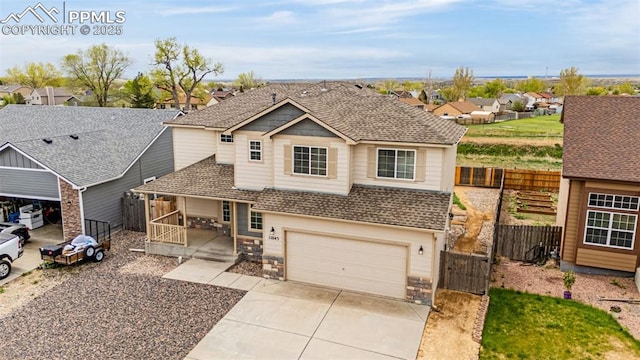 view of front of house with fence, a shingled roof, an attached garage, a gate, and driveway