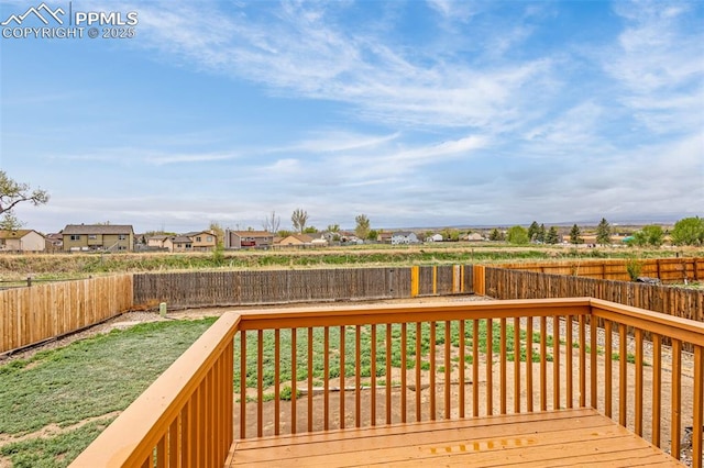 deck with a fenced backyard and a residential view