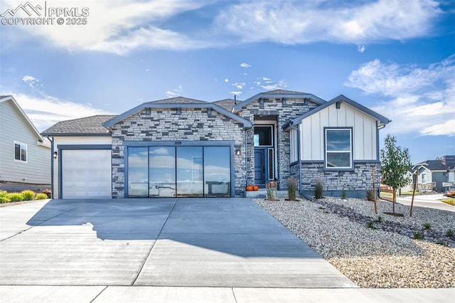 view of front of property featuring board and batten siding, an attached garage, concrete driveway, and stone siding