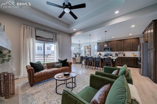 living room featuring recessed lighting, ceiling fan, and light wood finished floors