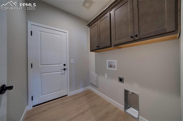 washroom with baseboards, hookup for a washing machine, cabinet space, electric dryer hookup, and light wood-style flooring