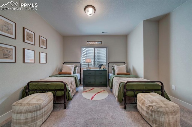 bedroom with visible vents, a textured ceiling, baseboards, and light carpet
